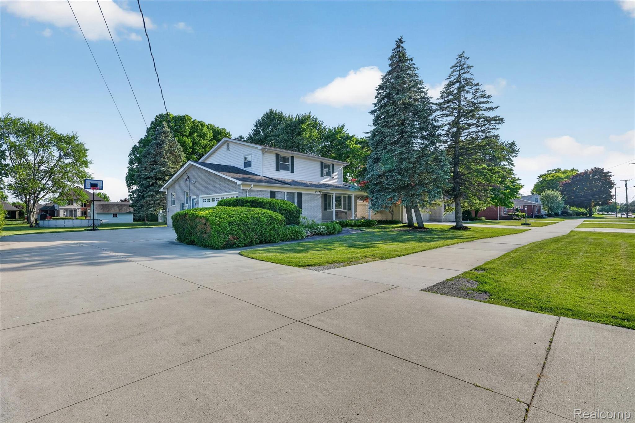 18178 22 Mile Road Macomb, MI 48044 - Photo 2 of 43 Two-story residence featuring a partial stone facade and attached garage