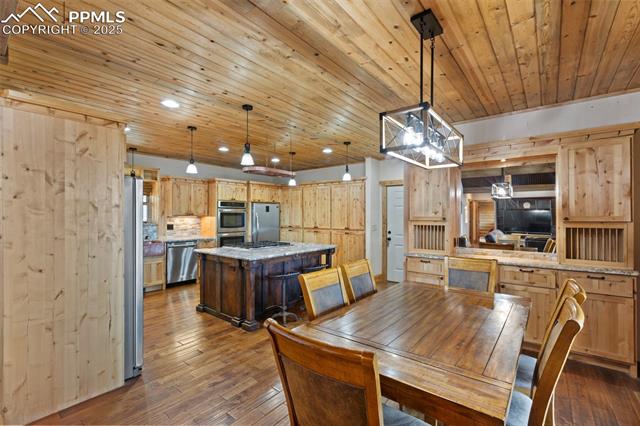 111 Blue Spruce Road Divide, CO 80814 - Photo 15 of 46 Dining space with dark wood-style flooring, wooden ceiling, and recessed lighting