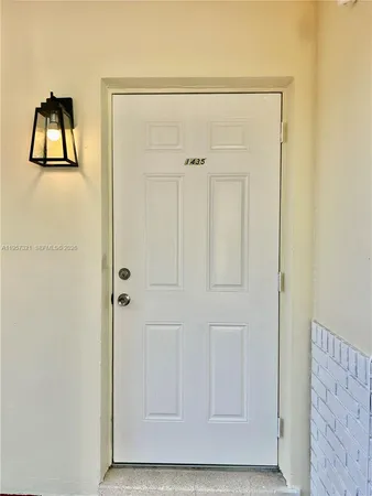 a view of staircase and front door