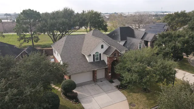 an aerial view of a house with a yard basket ball court and outdoor seating