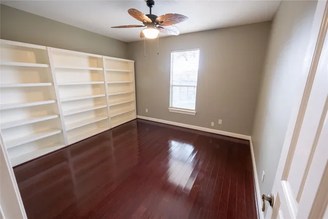 a view of room with window and wooden floor