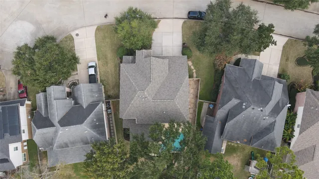 an aerial view of a house with outdoor space and a fountain