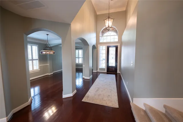a view of a livingroom with wooden floor and furniture