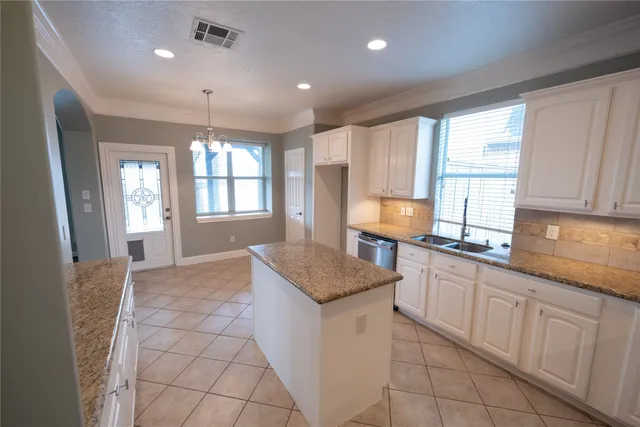 a kitchen with sink cabinets and window