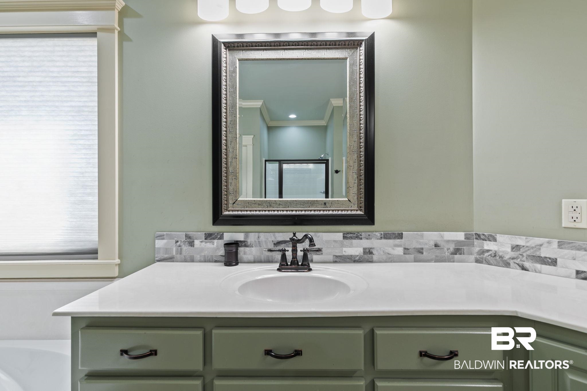 9584 Sanibel Loop Daphne, AL 36526 - Photo 24 of 48 Bathroom featuring ornamental molding, vanity, a bath, and tasteful backsplash