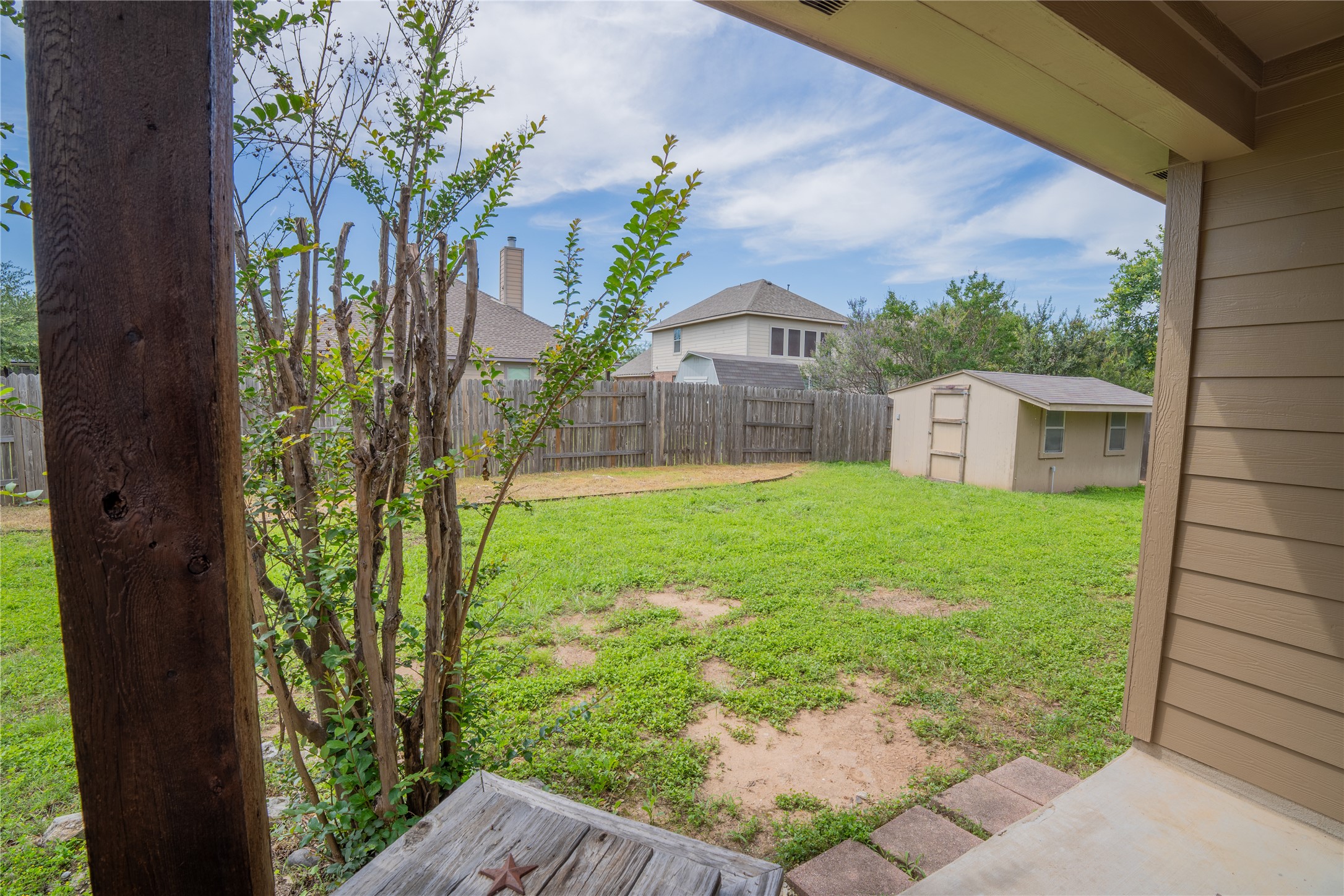 403 Tascate Street Georgetown, TX 78628 - Photo 25 of 26 A quaint backyard featuring a verdant lawn and a practical storage shed.