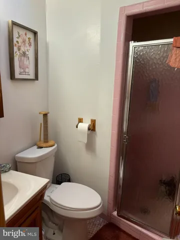 a white toilet sitting next to a bathroom sink