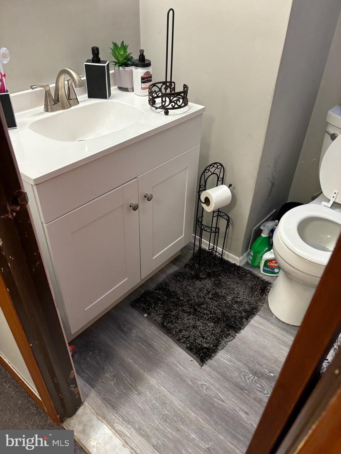 1513 Rainer Road Brookhaven, PA 19015 - Photo 17 of 21 a bathroom with a sink a toilet and mirror