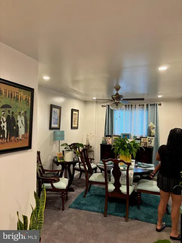 a living room with furniture a air conditioner vent and a window