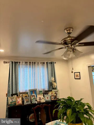 a room with a chandelier furniture and a potted plant