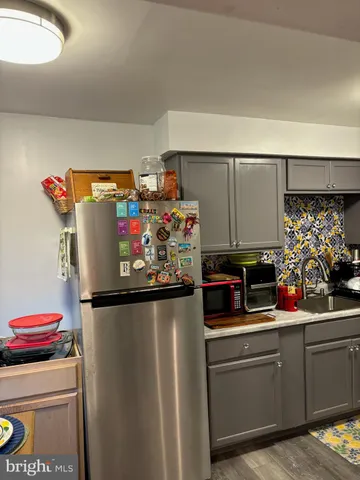 a kitchen with refrigerator and cabinets