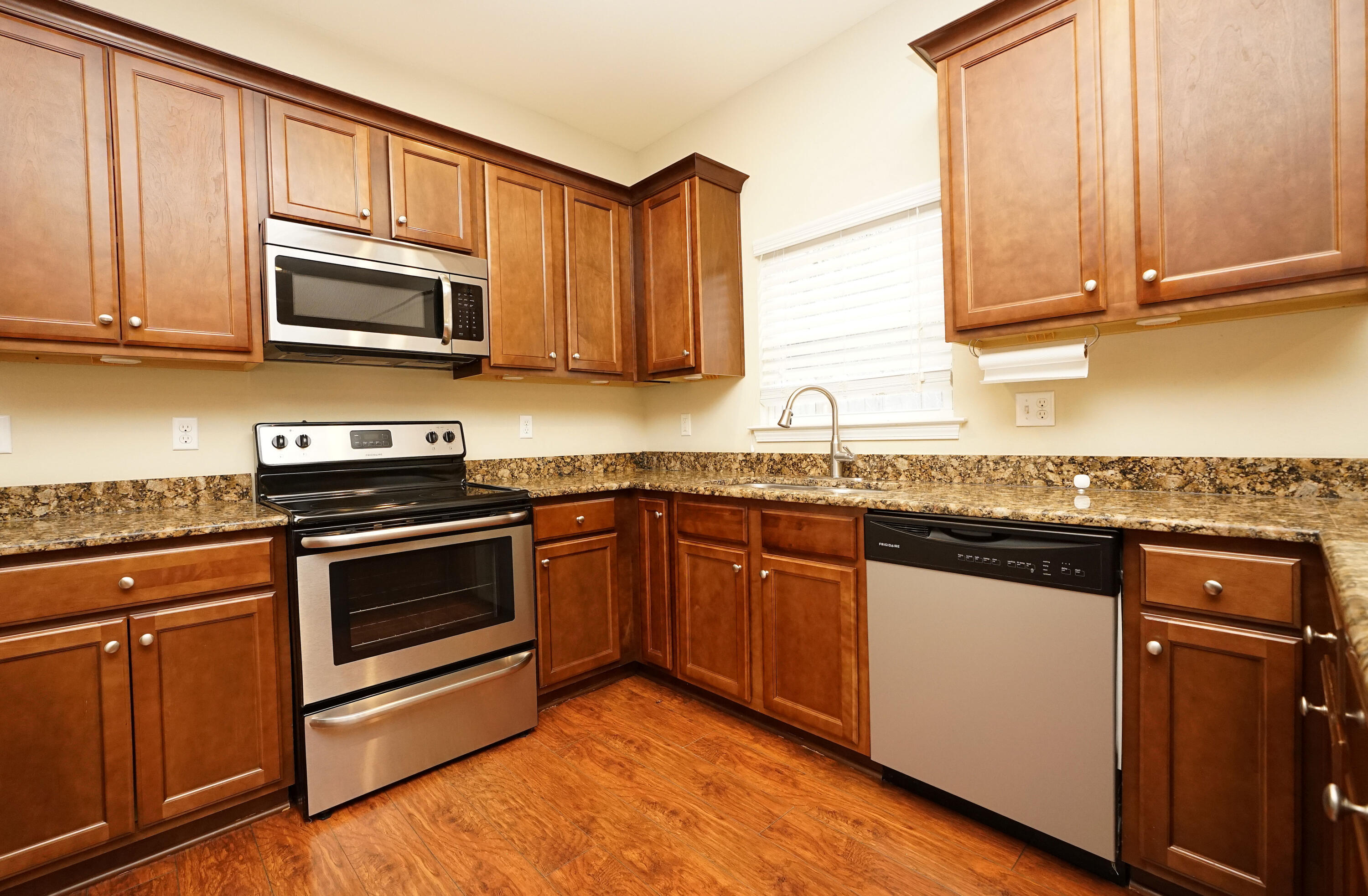 1305 Finck Road Niceville, FL 32578 - Photo 11 of 28 a kitchen with stainless steel appliances granite countertop a stove microwave and sink