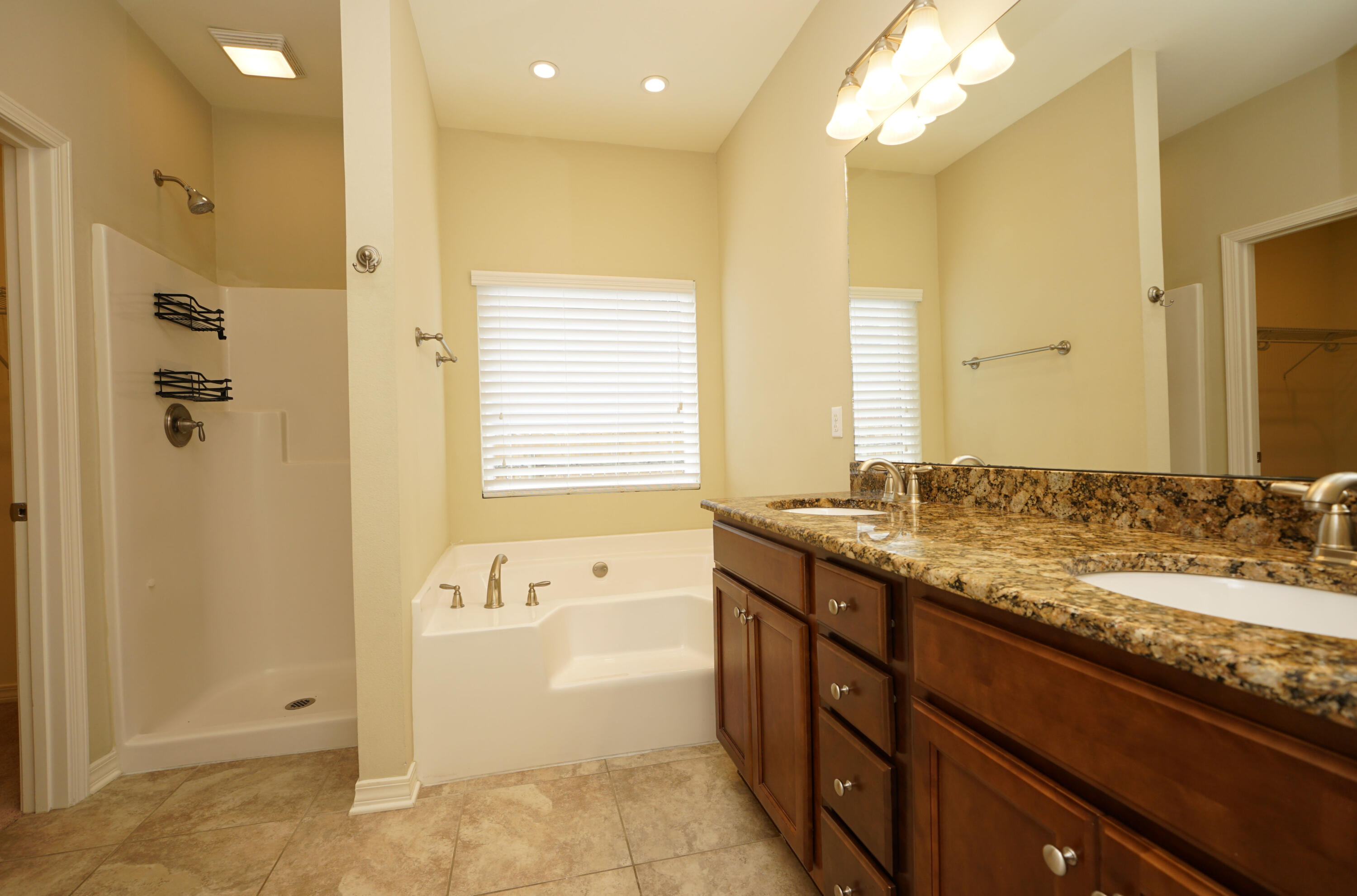 1305 Finck Road Niceville, FL 32578 - Photo 14 of 28 a bathroom with a granite countertop sink mirror and a bathtub