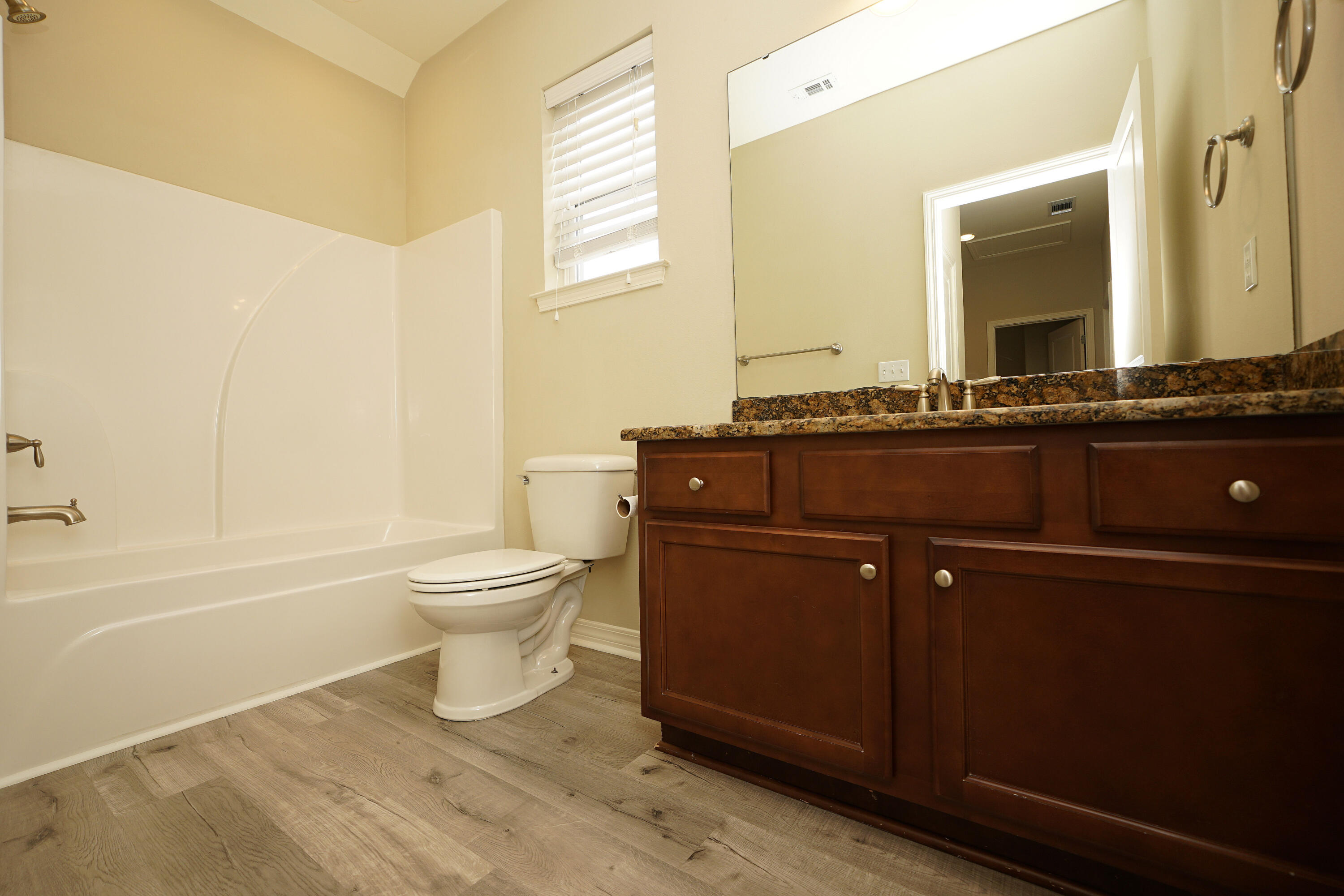 1305 Finck Road Niceville, FL 32578 - Photo 21 of 28 a bathroom with a granite countertop toilet a sink and a bathtub
