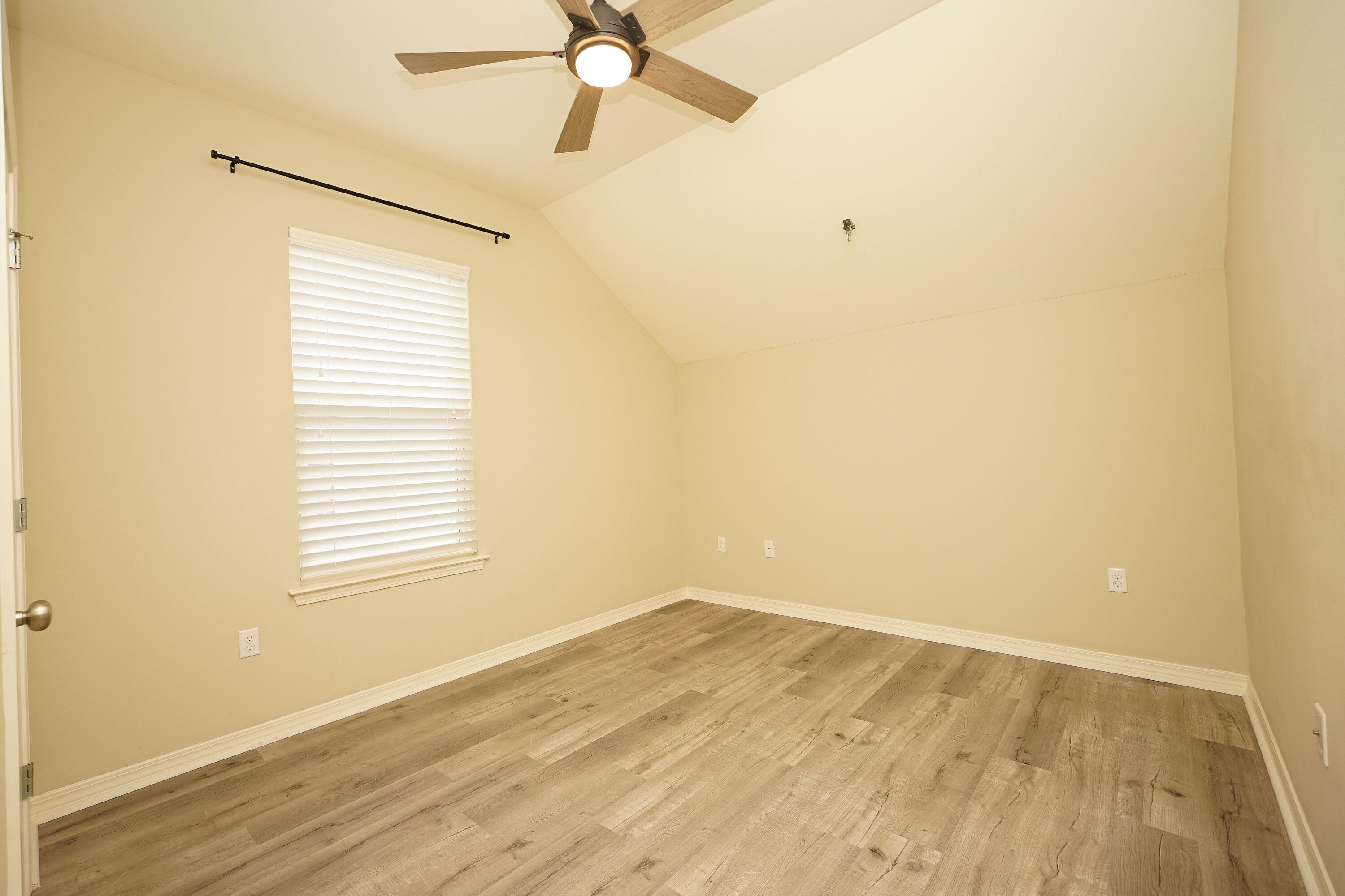 1305 Finck Road Niceville, FL 32578 - Photo 23 of 28 a view of an empty room with wooden floor and a window