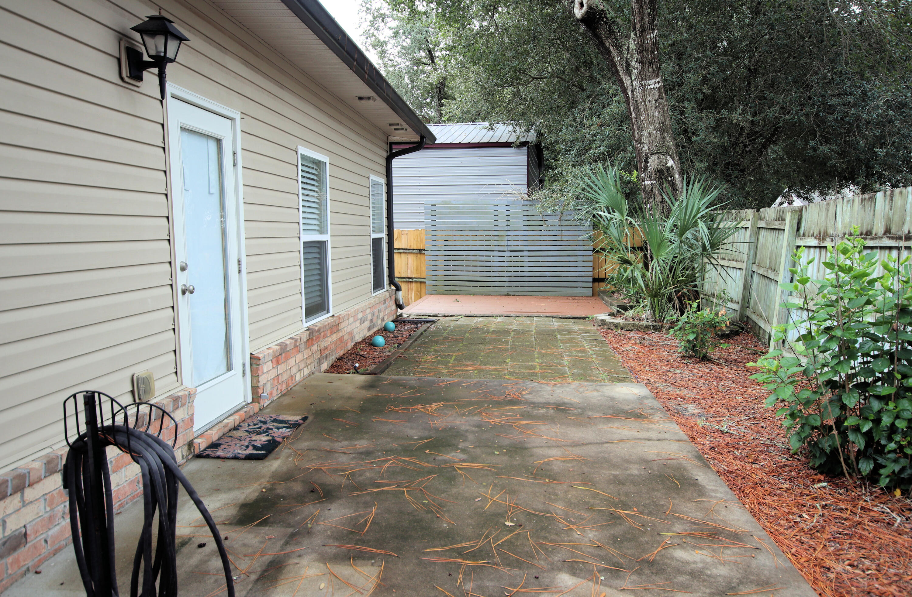 1305 Finck Road Niceville, FL 32578 - Photo 26 of 28 a view of a backyard with sitting area