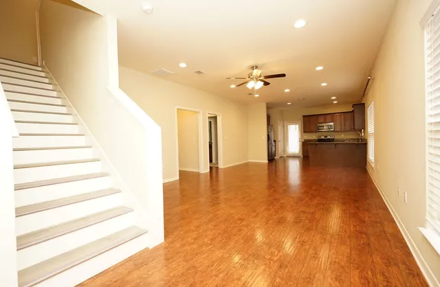 a view of entryway and hall with wooden floor