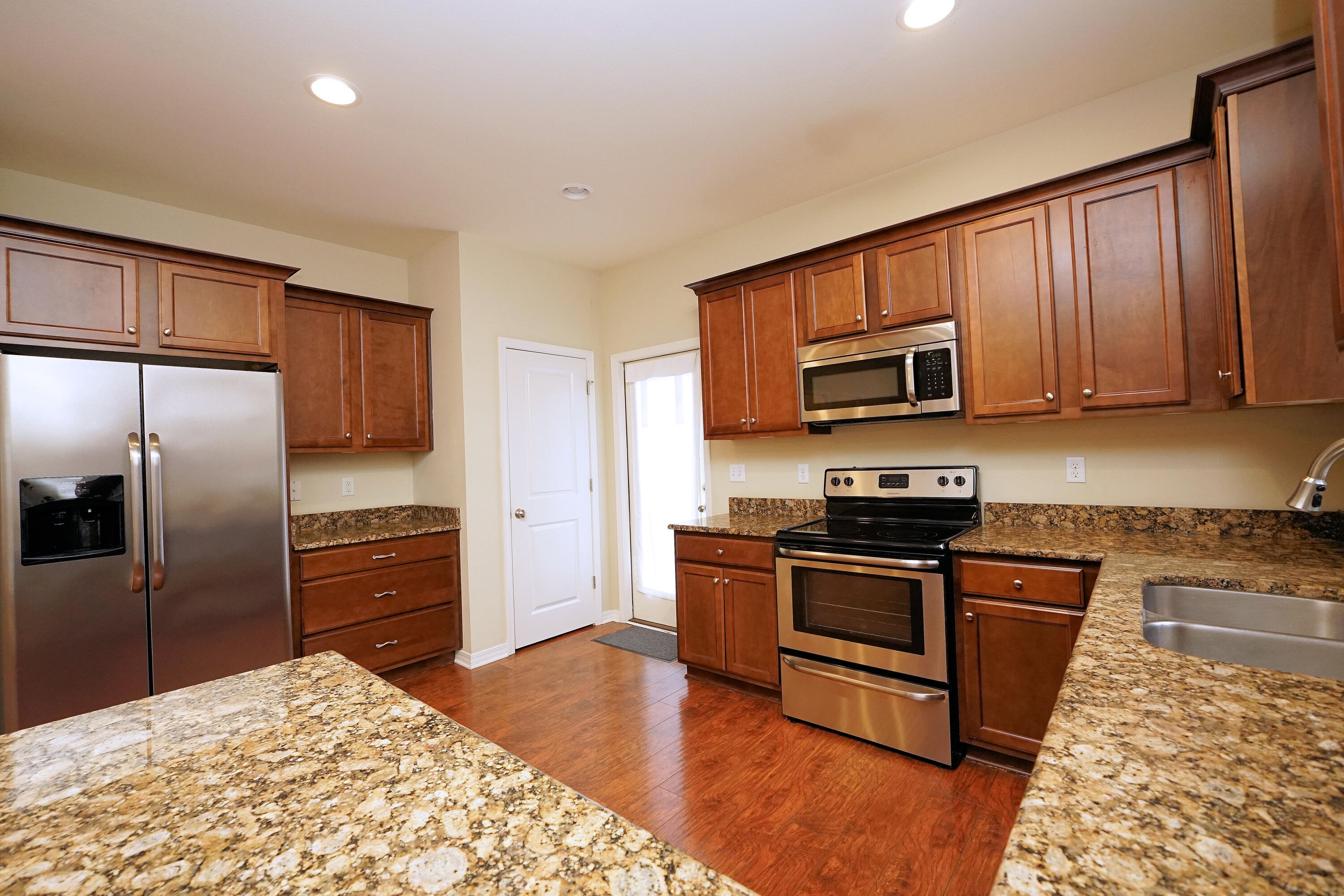 1305 Finck Road Niceville, FL 32578 - Photo 9 of 28 a kitchen with granite countertop wooden cabinets a stainless steel appliances and a center island