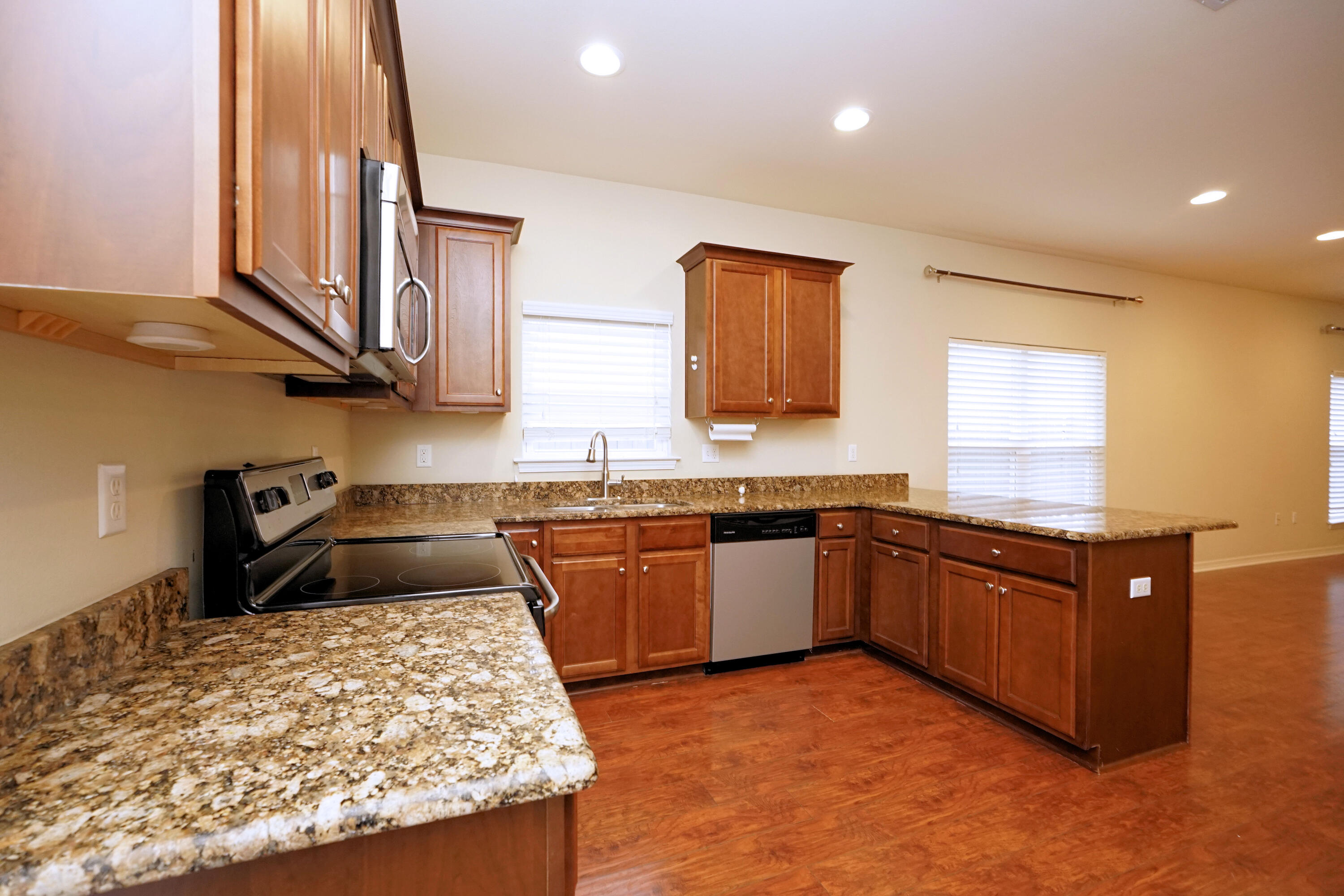 1305 Finck Road Niceville, FL 32578 - Photo 10 of 28 a kitchen with stainless steel appliances granite countertop a sink stove and granite counter top