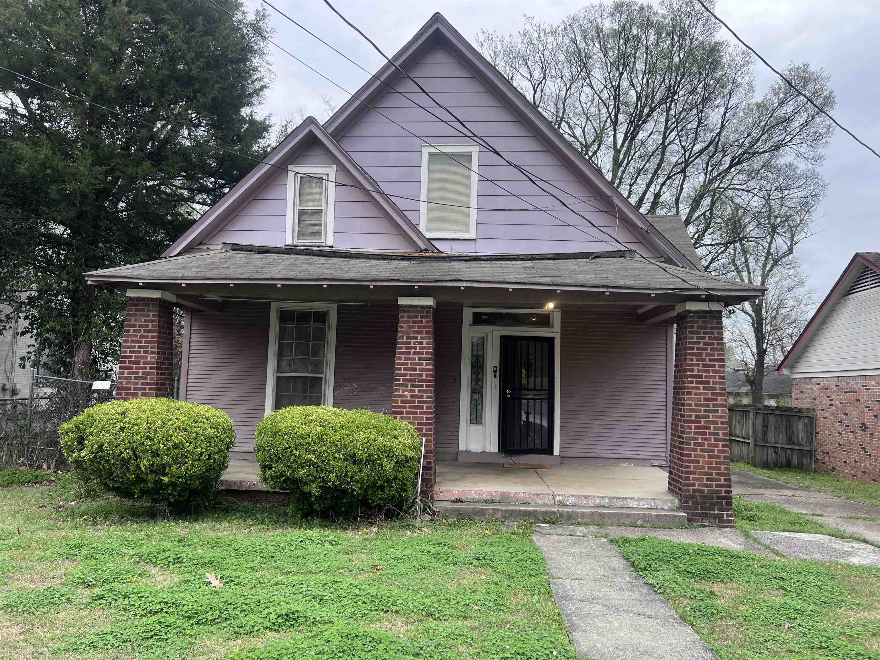 946 Roland Street Memphis, TN 38114 - Photo 1 of 32 a view of a house with a yard plants and large tree