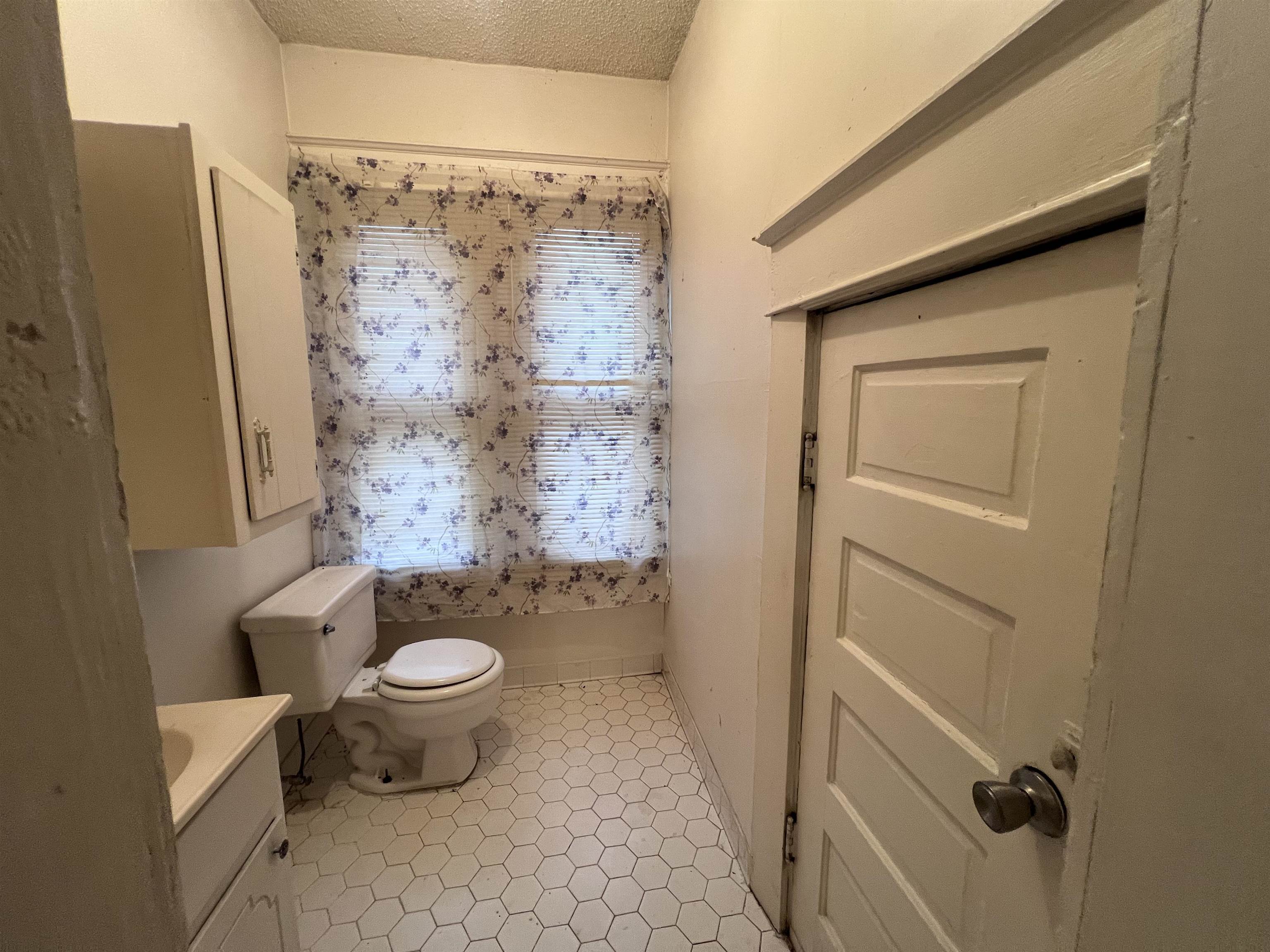 946 Roland Street Memphis, TN 38114 - Photo 22 of 32 a bathroom with a granite countertop sink toilet and shower