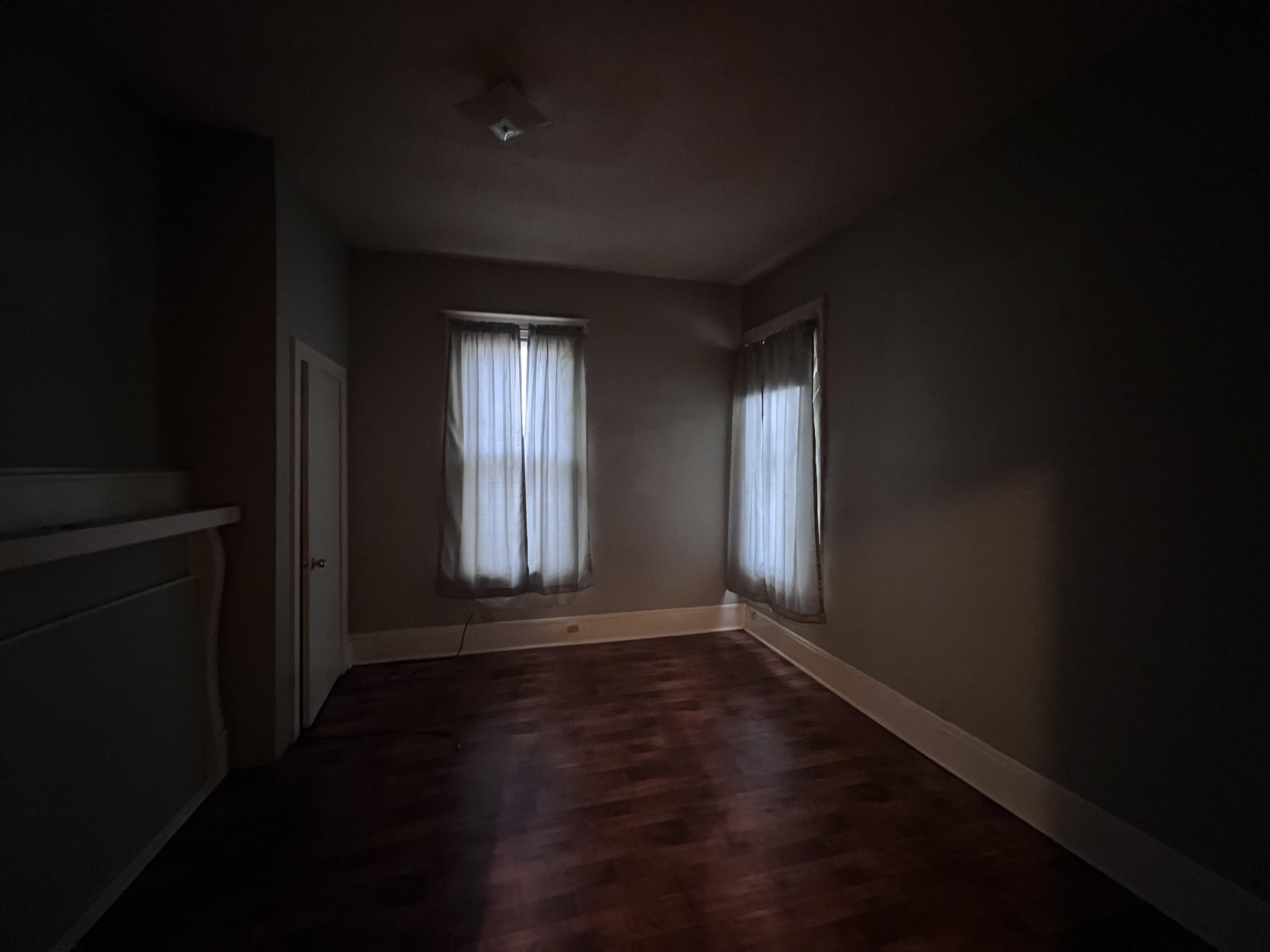 946 Roland Street Memphis, TN 38114 - Photo 26 of 32 a view of an empty room with wooden floor and a window