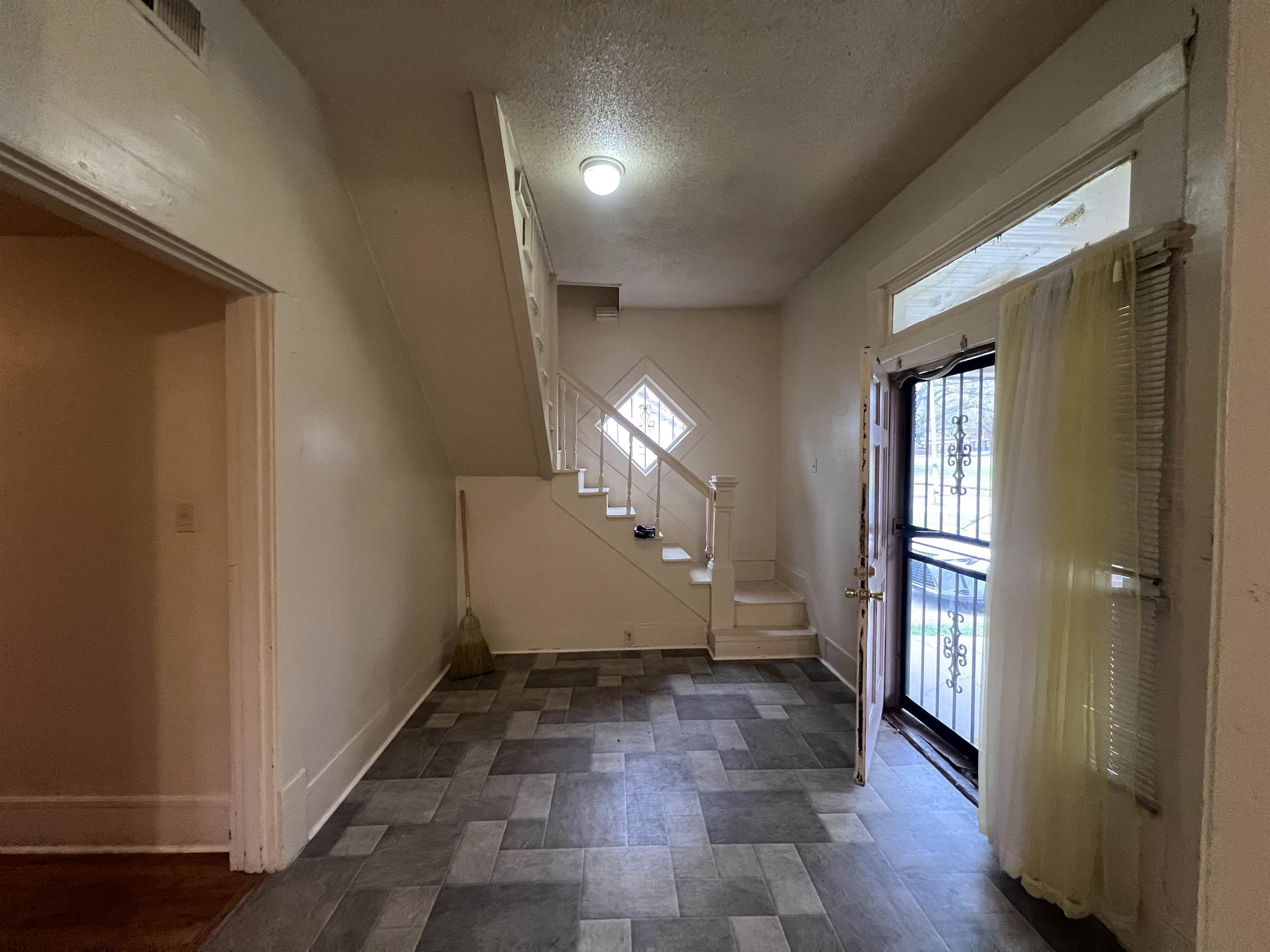 946 Roland Street Memphis, TN 38114 - Photo 8 of 32 an empty room with wooden floor and windows