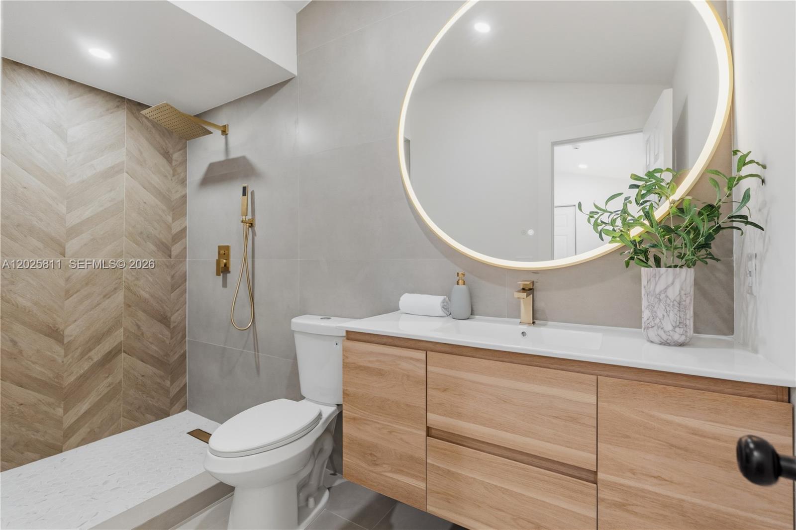 2110 Southwest 15th Street Miami, FL 33145 - Photo 28 of 37 a bathroom with a granite countertop toilet sink and mirror