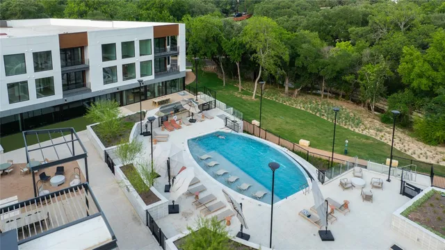 an aerial view of a house with swimming pool garden and patio