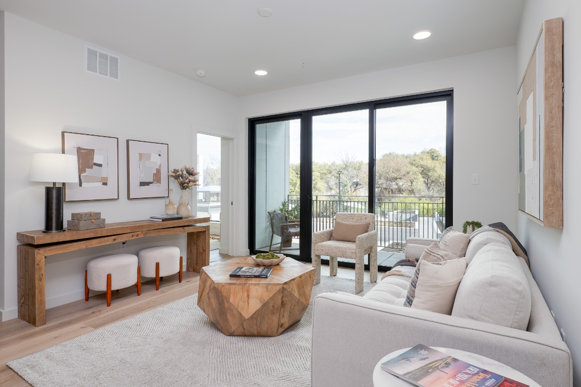 2209 South 1st Street, Unit 237 Austin, TX 78704 - Photo 6 of 25 a living room with furniture and a large window