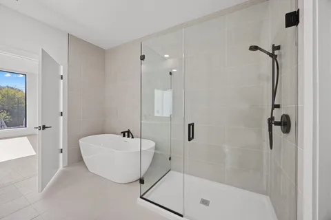 a bathroom with a bathtub and shower