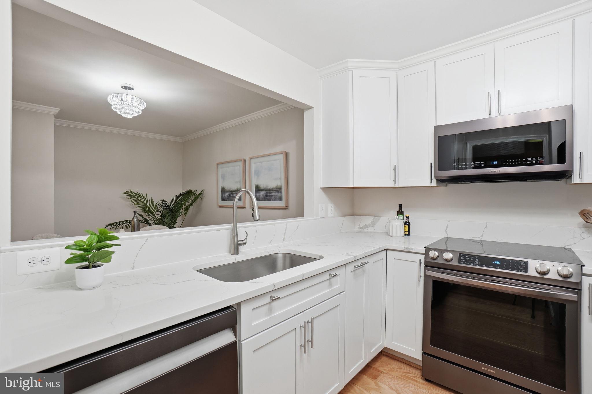 1495 Church Hill Place Reston, VA 20194 - Photo 3 of 27 a kitchen with stainless steel appliances white cabinets a sink and a stove