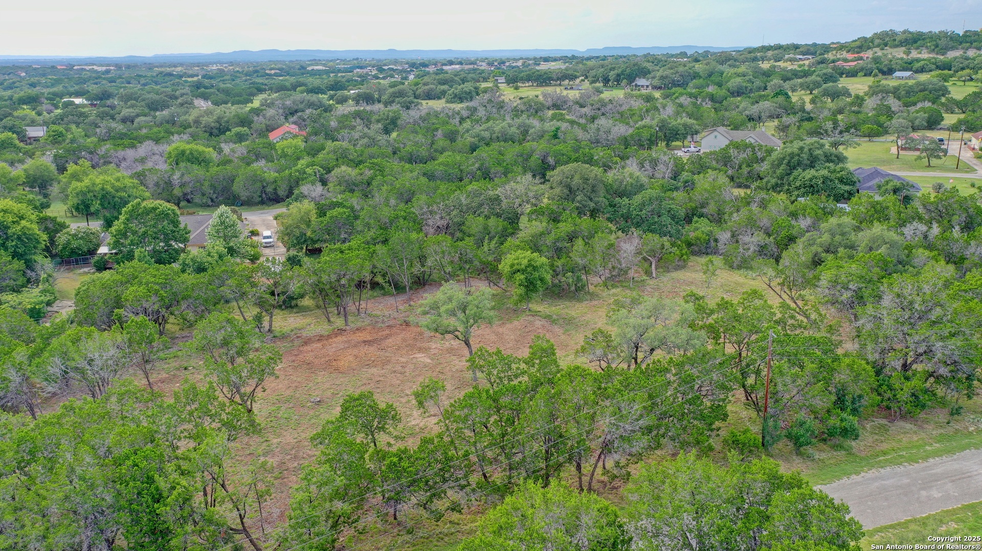 Lot 4 Heinen Bandera, TX 78003 - Photo 2 of 23 a view of a forest with a street