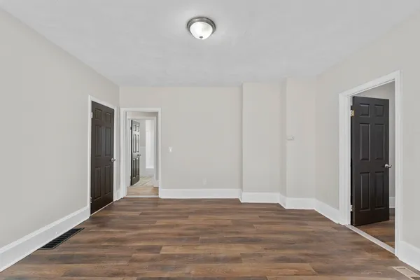 a view of wooden floor and windows in a room