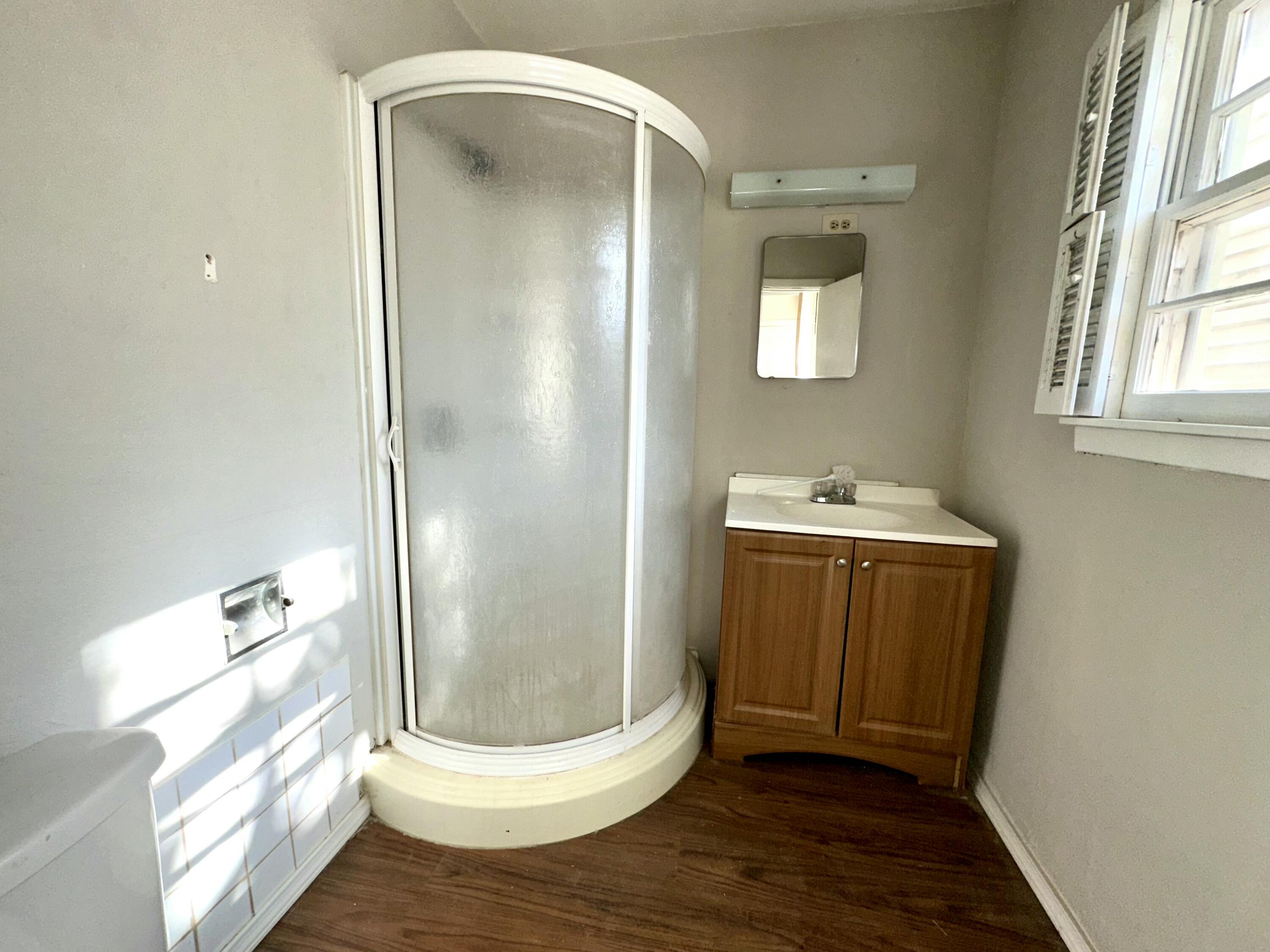 3012 22nd Street Lubbock, TX 79410 - Photo 11 of 11 a bathroom with a glass door shower and a sink
