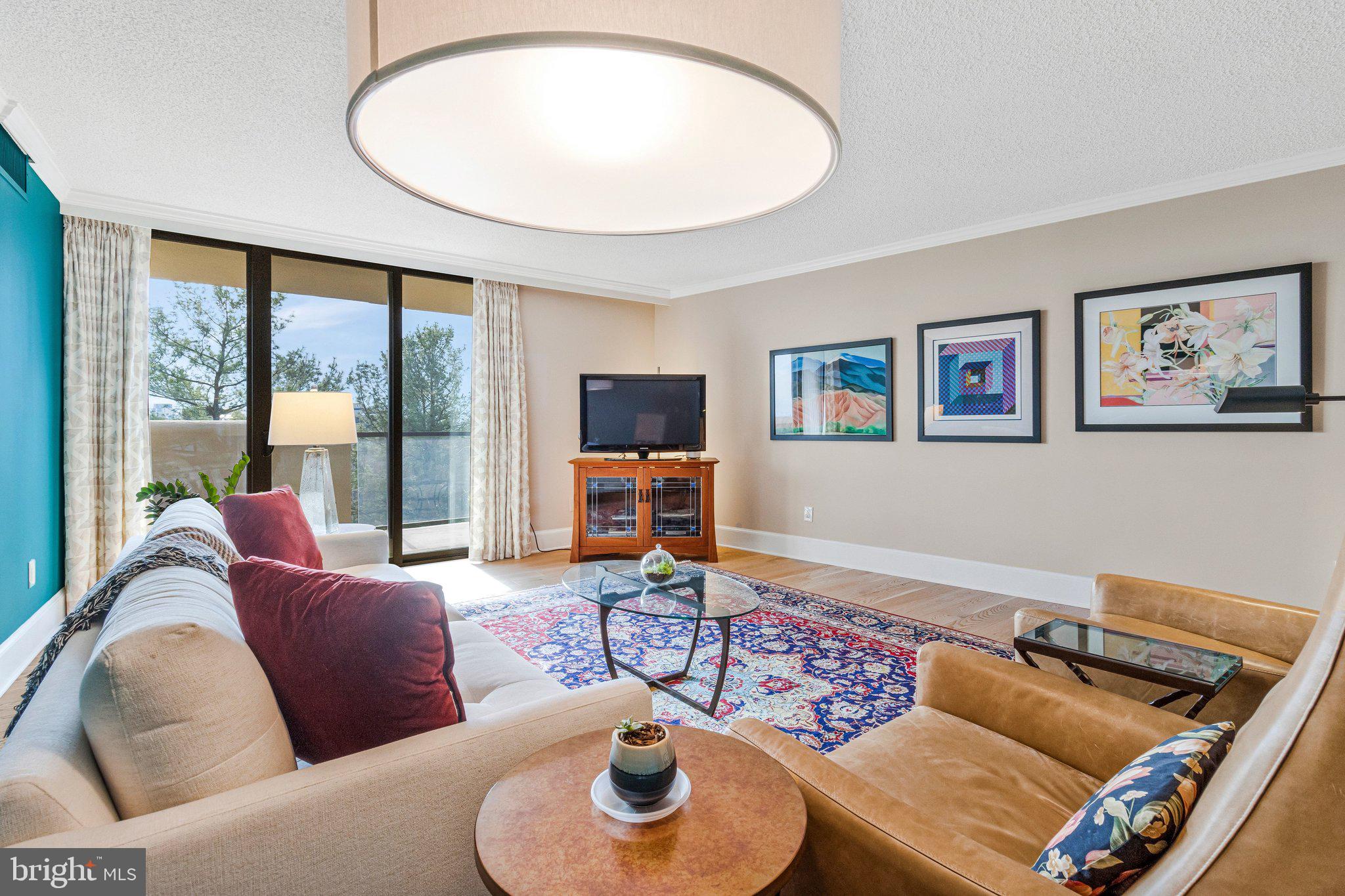 1101 South Arlington Ridge Road, Unit 706 Arlington, VA 22202 - Photo 15 of 59 a living room with furniture and a flat screen tv