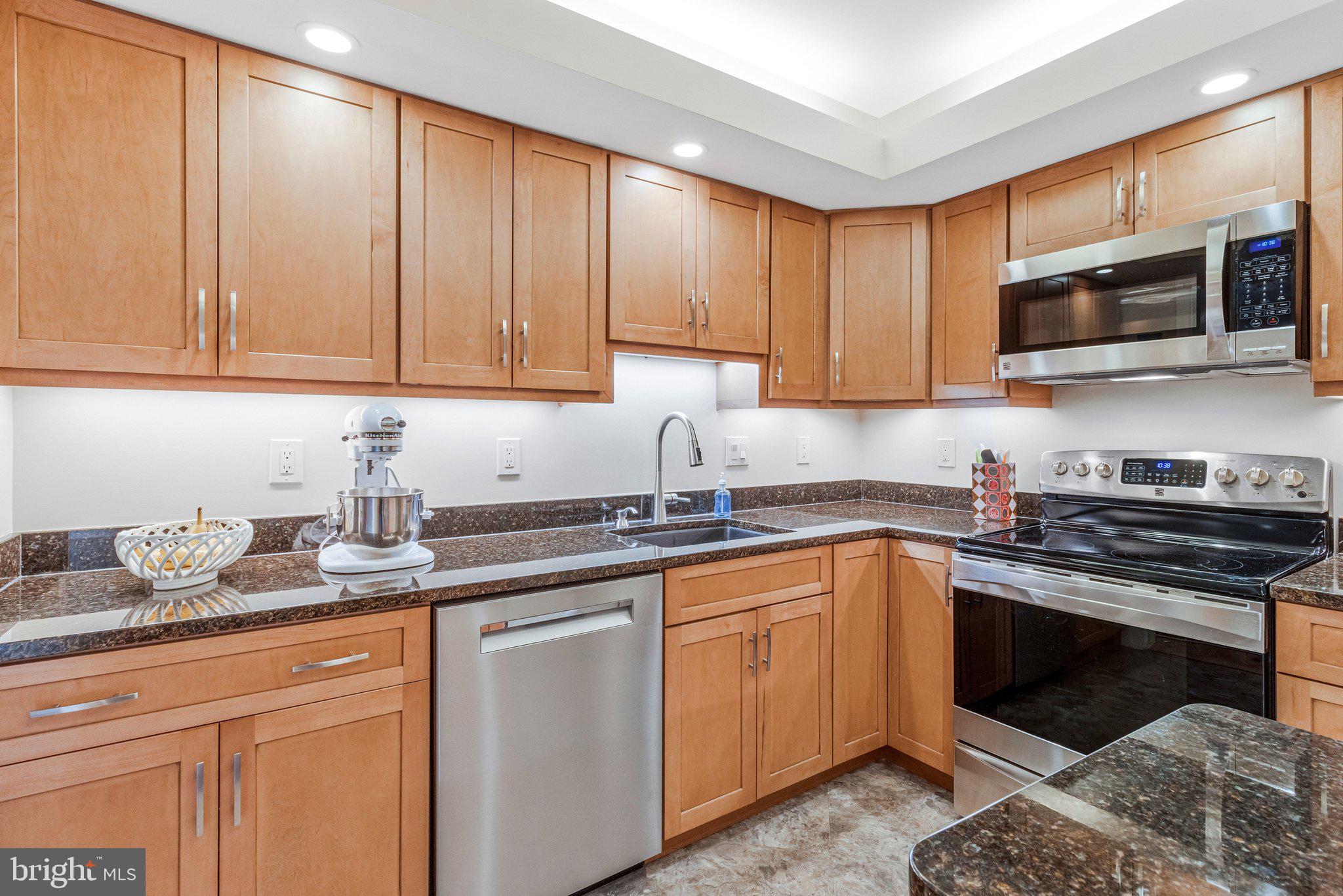 1101 South Arlington Ridge Road, Unit 706 Arlington, VA 22202 - Photo 22 of 59 a kitchen with stainless steel appliances granite countertop a sink stove and microwave