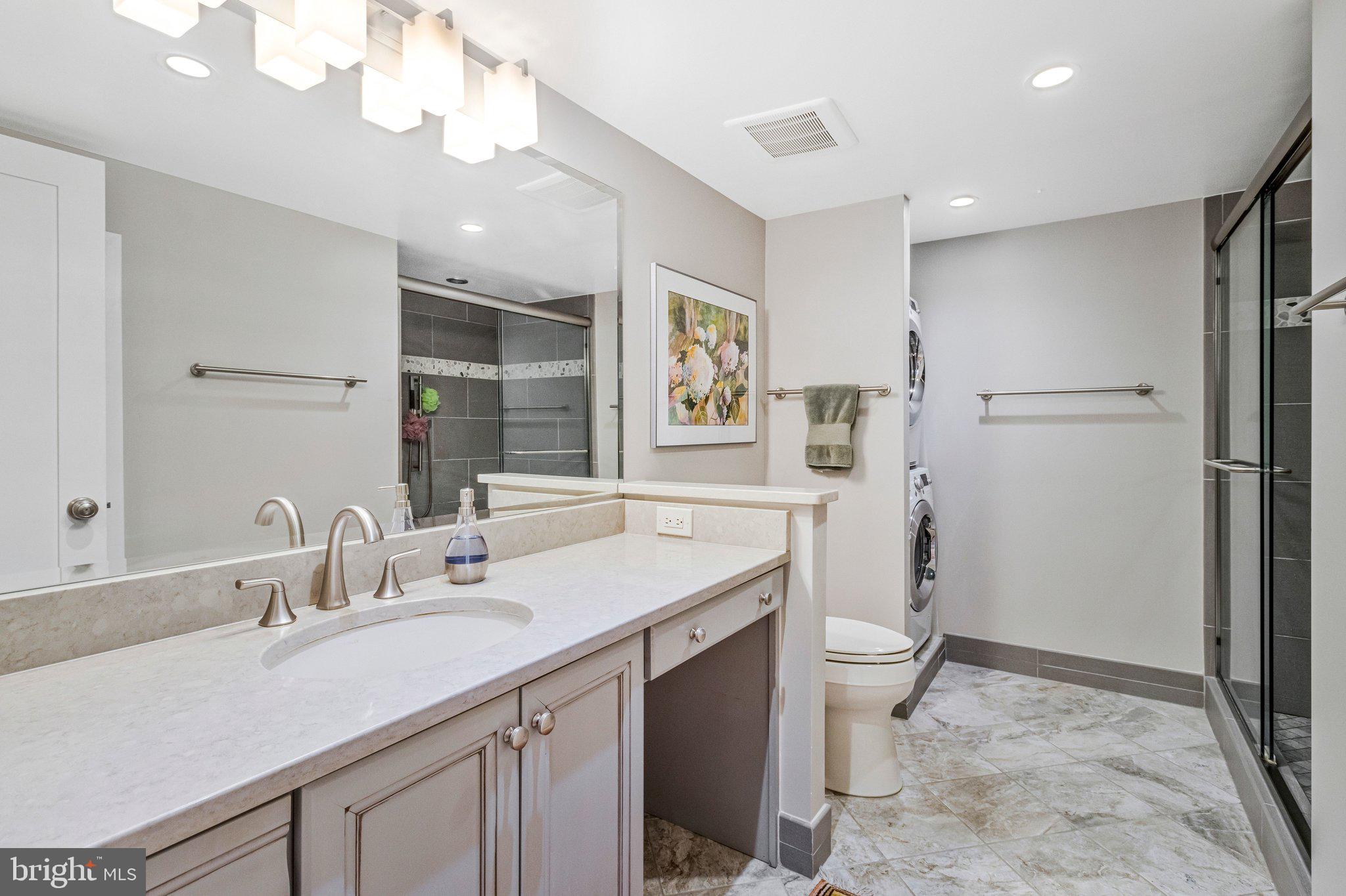 1101 South Arlington Ridge Road, Unit 706 Arlington, VA 22202 - Photo 33 of 59 a bathroom with a sink a toilet a mirror and vanity