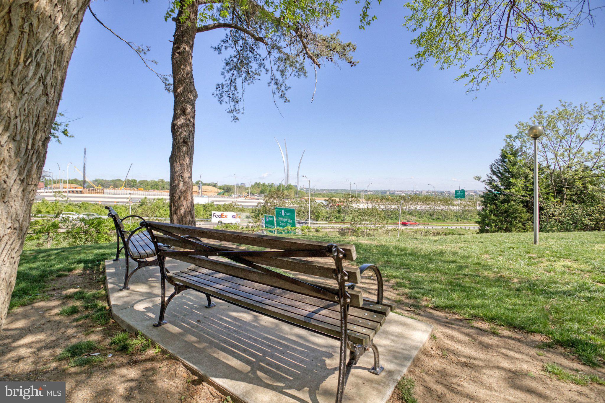 1101 South Arlington Ridge Road, Unit 706 Arlington, VA 22202 - Photo 57 of 59 a view of a bench in the garden near a lake