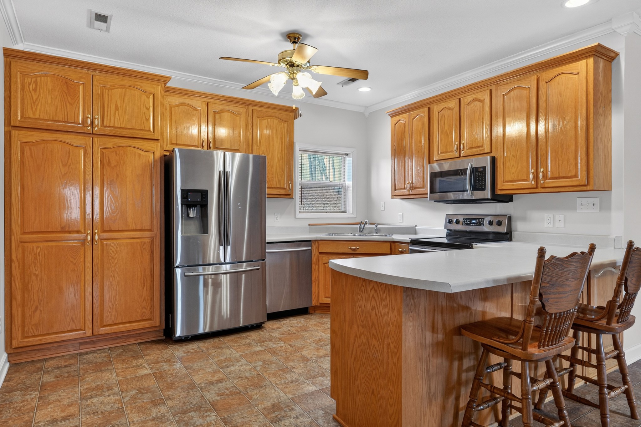 31 Frame Lane Kelso, TN 37348 - Photo 11 of 27 a kitchen with stainless steel appliances granite countertop a refrigerator a stove a sink a dining table and chairs with wooden floor