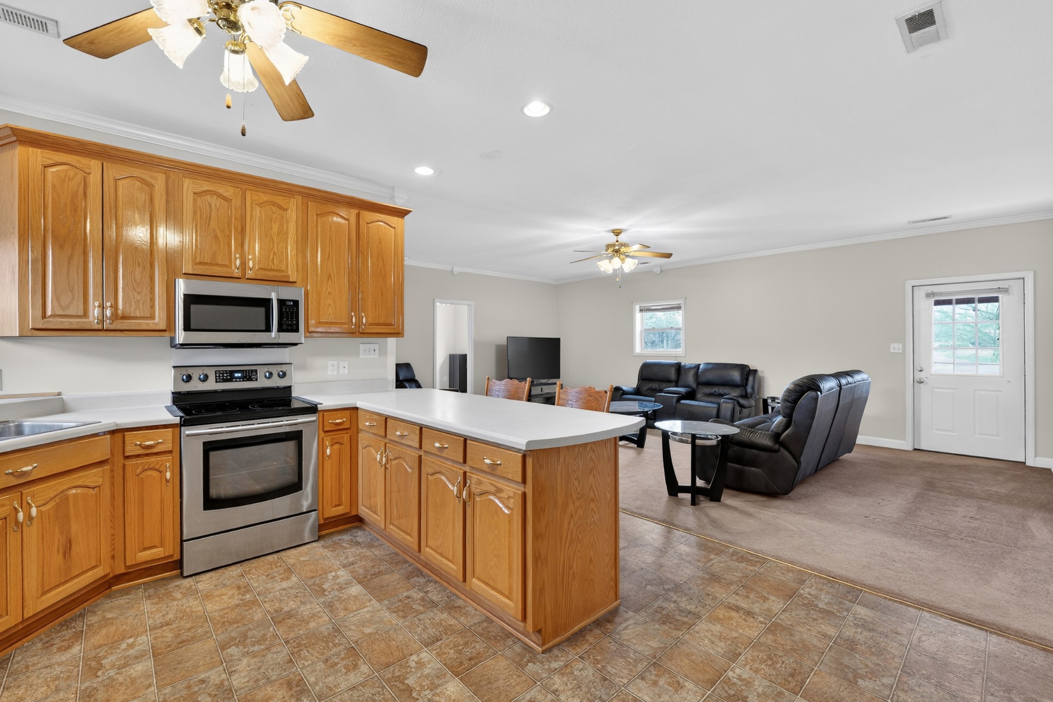 31 Frame Lane Kelso, TN 37348 - Photo 15 of 27 a kitchen with a stove a microwave and living room view