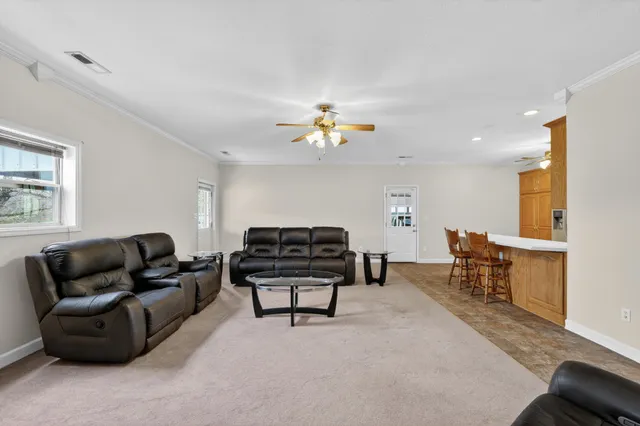 a living room with furniture and a chandelier
