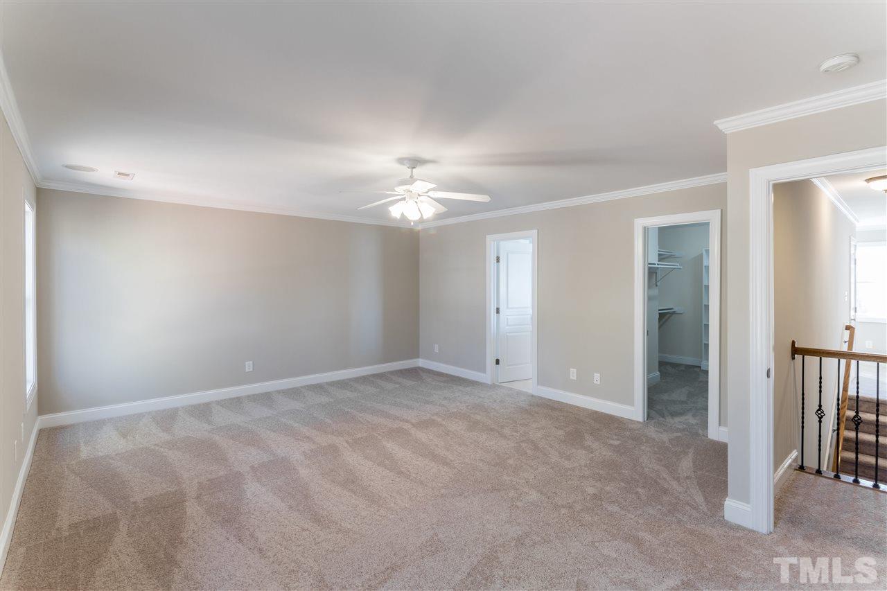 5741 Spring Glen Lane Raleigh, NC 27616 - Photo 21 of 25 a view of an empty room with a chandelier fan