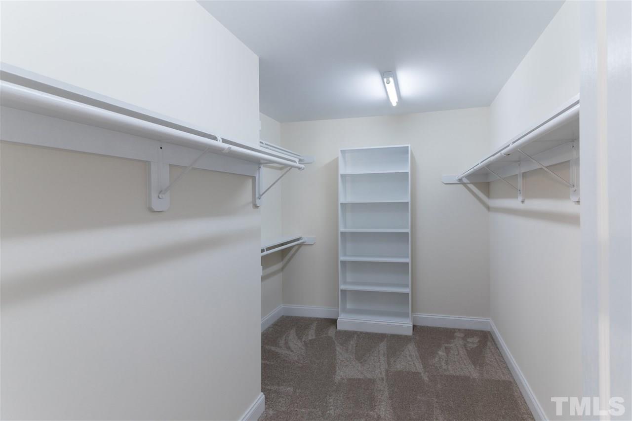 5741 Spring Glen Lane Raleigh, NC 27616 - Photo 22 of 25 a view of walk in closet with empty racks