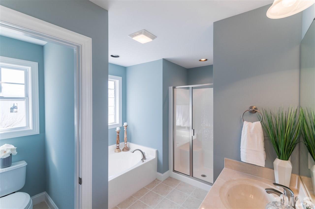 5741 Spring Glen Lane Raleigh, NC 27616 - Photo 23 of 25 a bathroom with a tub shower and toilet