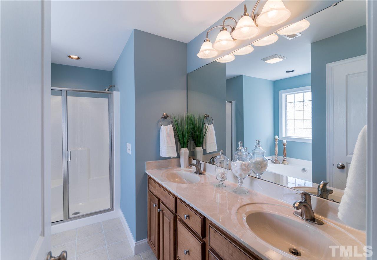 5741 Spring Glen Lane Raleigh, NC 27616 - Photo 24 of 25 a bathroom with a sink vanity and a mirror