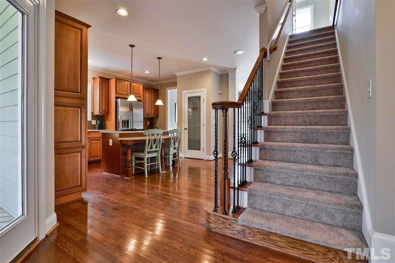 5741 Spring Glen Lane Raleigh, NC 27616 - Photo 7 of 25 a view of a dining room with furniture entryway and wooden floor