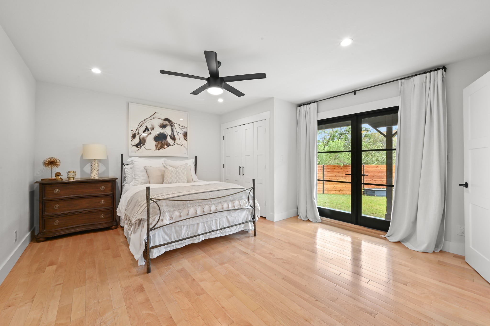 3 Timberline Ridge Austin, TX 78746 - Photo 15 of 21 Bedroom featuring light wood-finish flooring, recessed lighting, and a modern ceiling fan. Direct access to yard.