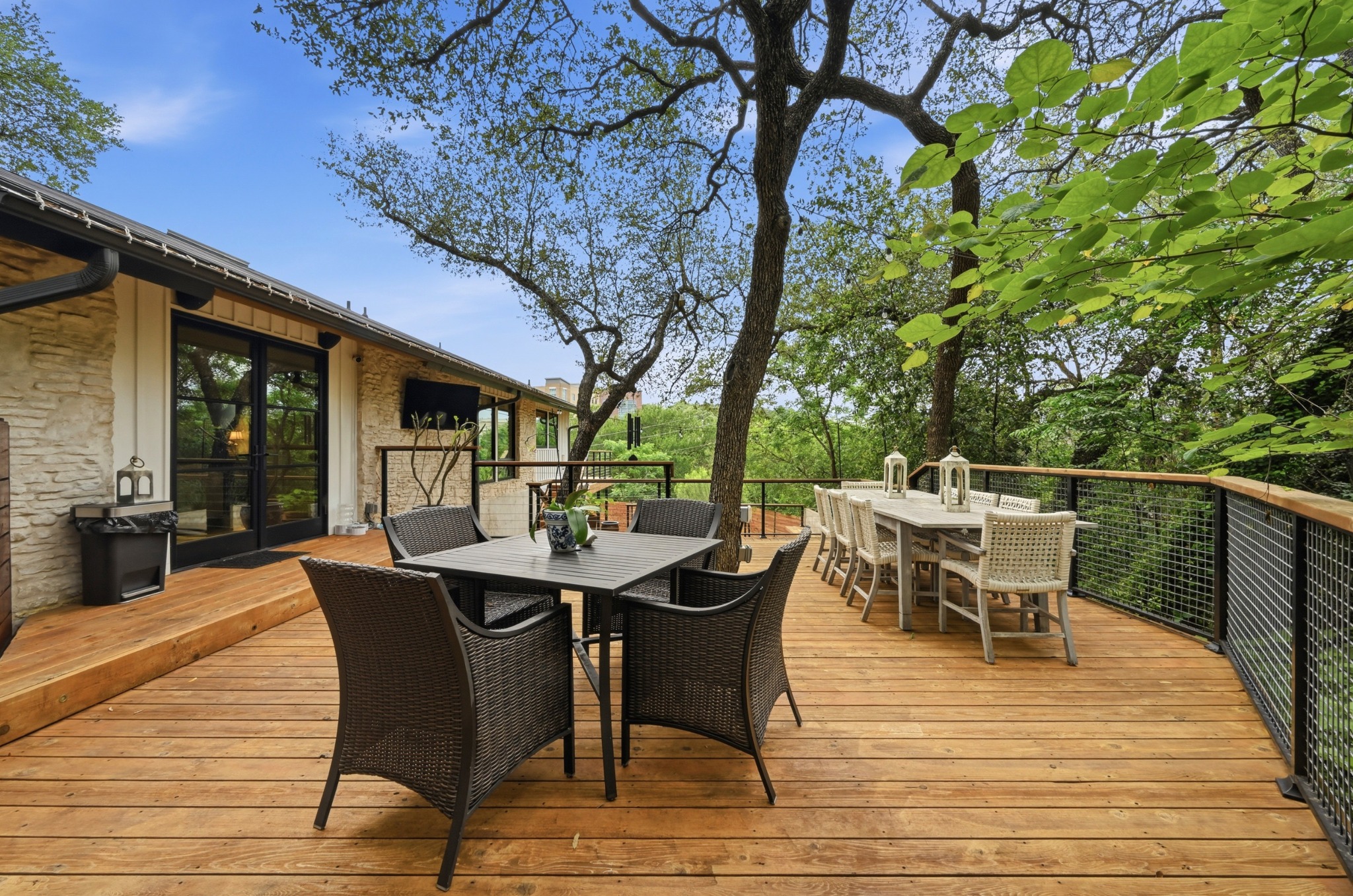 3 Timberline Ridge Austin, TX 78746 - Photo 19 of 21 Expansive wood deck with a curved architectural design, featuring a metal and wood railing