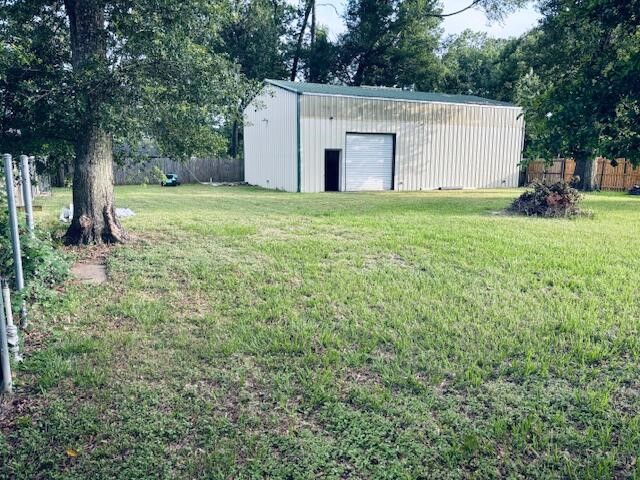 802 Fall Creek Drive Huffman, TX 77336 - Photo 6 of 17 a view of a house with backyard and a tree